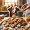 A warm and inviting scene featuring a batch of freshly baked mini biscuits on a kitchen counter. The biscuits are golden brown, shaped in small, fun d