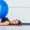 portrait-brunette-pretty-woman-she-is-lying-with-blue-fitness-ball-floor