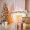 white-fireplace-decorated-with-yellow-garland-christmas-tree-standing-by-it